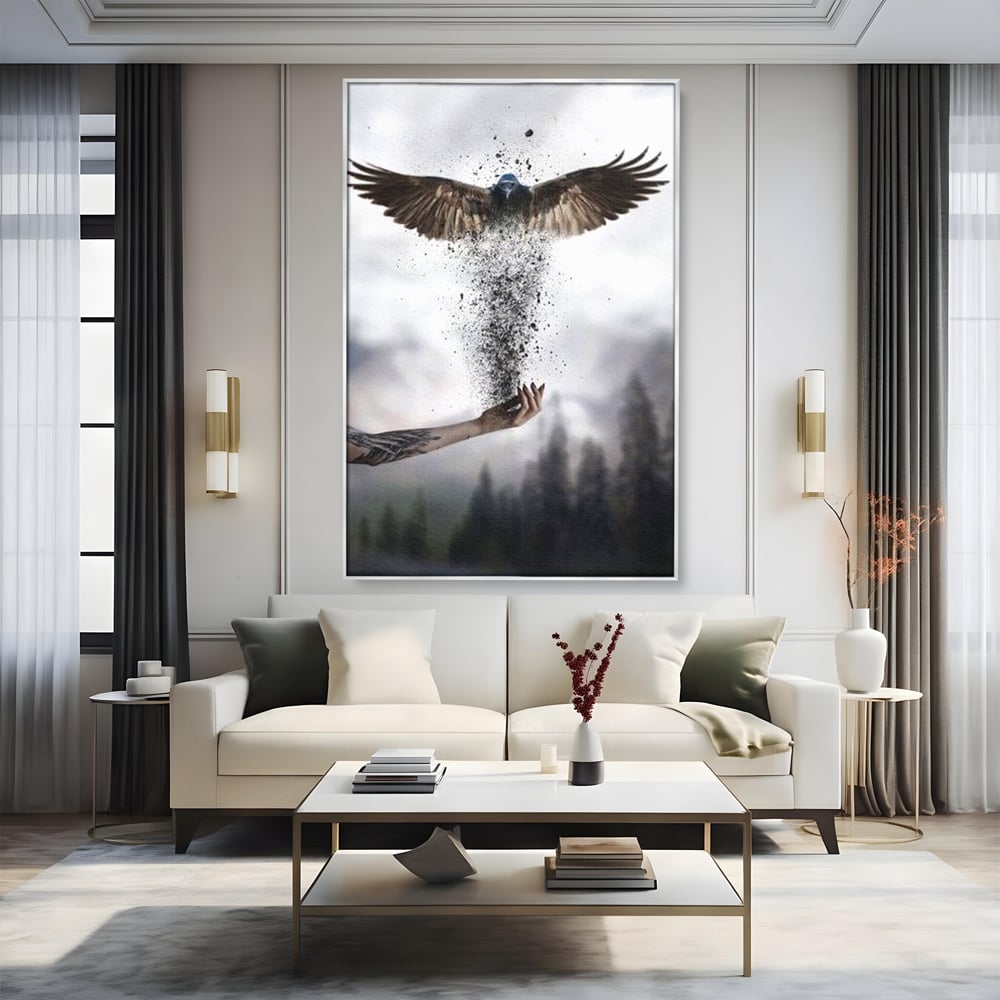 Tablou canvas cu tablou canvas cu pasare si mana din cenusa, in rama de aluminiu argintiu, pe perete intr-un living